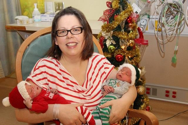 Woman holding two newborns