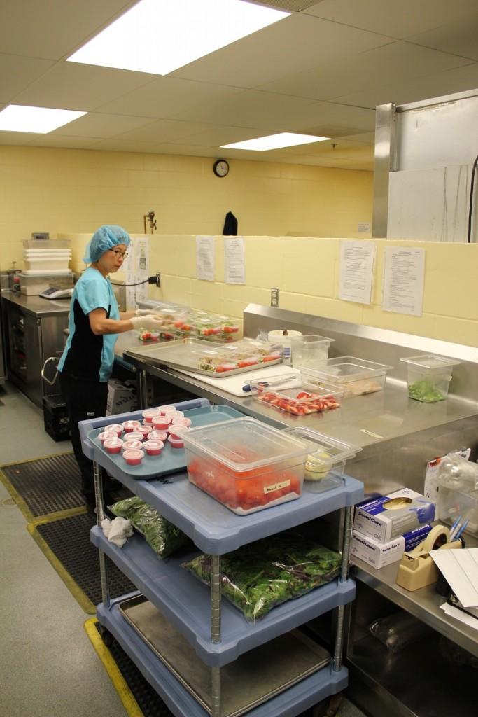 TBRHSC cafeteria worker preparing food