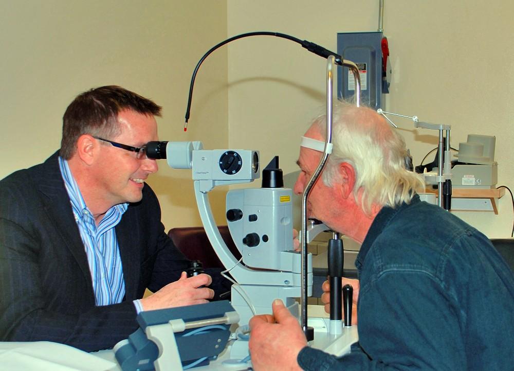 Ophthalmologist Dr. Chris Francis (left) demonstrating one of the current lasers in the Lions Vision Care Centre at Thunder Bay Regional Health Sciences Centre. Without local laser eye surgery, patients would have to travel out of the region for these sight-saving procedures. The Health Sciences Foundation is raising money this summer for an upgraded unit to ensure cutting-edge care right here at home.