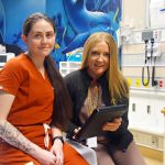 Stevie Fishwick (left) and Melissa Roulston demonstrate the Emergency Department’s new iPad, purchased with a Family CARE Grant. The tablet can be used to help patients Facetime family members, find community services, and even access translation services.
