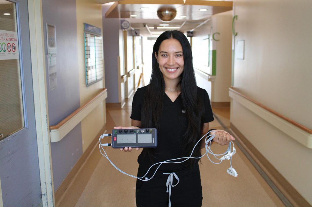 Emily P., RN, Intensive Care Unit (ICU) shows the new pulse generator made possible by proceeds of the Thunder Bay 50/50 Draw.