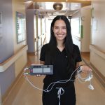 Emily P., RN, Intensive Care Unit (ICU) shows the new pulse generator made possible by proceeds of the Thunder Bay 50/50 Draw.