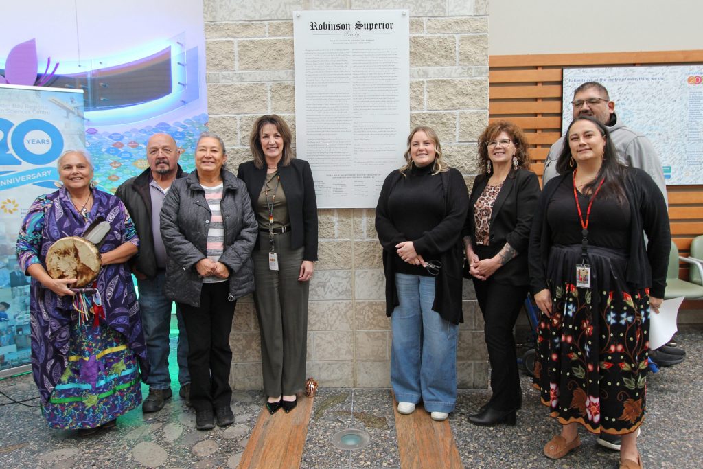 Unveiling of the Robinson Superior Treaty of 1850 plaque at Thunder Bay Regional Health Sciences Centre (TBRHSC). Photo (L-R): Elder Sheila DeCorte; Pays Plat First Nation Chief Mushquash; Animbiigoo Zaagi’igan Anishinaabek Chief Yvette Metansinine; Dr. Rhonda Crocker Ellacott, President & CEO, TBRHSC and CEO, Thunder Bay Regional Health Research Institute; Fort William First Nation Councillor Bess Legarde; Fort William First Nation Chief Michele Solomon, Red Rock Indian Band Chief Allan Odawa Jr.; Dr. Miranda Lesperance, VP, Indigenous Collaboration Equity, & Inclusion.