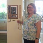 Kirsten Kay ringing the bell at Thunder Bay Regional Health Sciences Center’s Regional Cancer Care, marking the end of her radiation treatment.